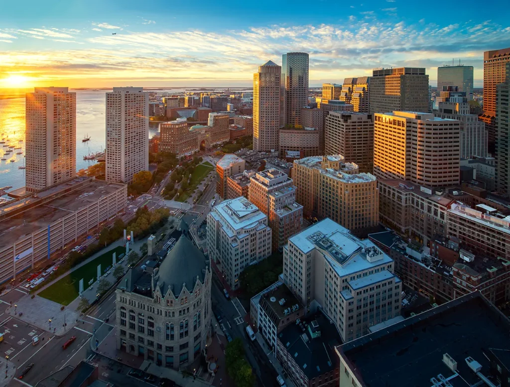 Boston city skyline at sunset highlighting urban planning aligned with Net Zero building strategy.